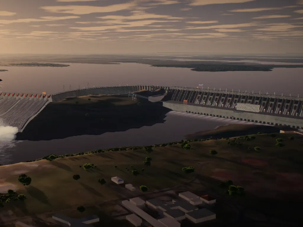 The Itaipu dam at sunset from the air: the spillway throwing spray into the river, the reservoir behind it and buildings on the near bank.